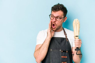 Kafkasyalı genç kunduracı, mavi arka planda izole edilmiş bir şekilde gizli bir sıcak fren haberinin olduğunu söylüyor.