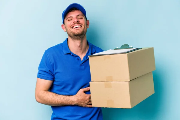 Young Caucasian Delivery Man Isolated Blue Background Laughing Having Fun — стоковое фото