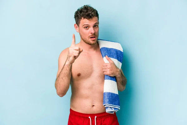 Young Caucasian Man Holding Beach Towel Isolated Blue Background Having — Photo