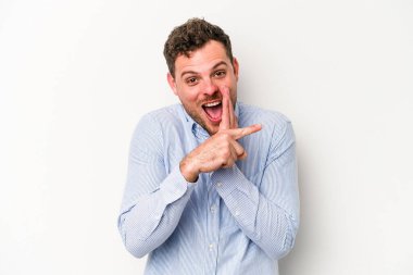 Beyaz arka planda izole edilmiş genç beyaz bir adam bir dedikodu söylüyor, bir haber sunuyor..