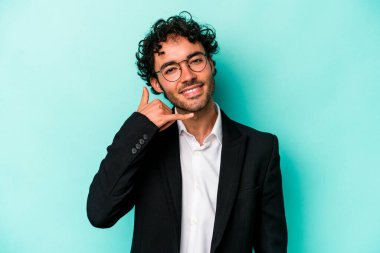 Kafkasyalı genç iş adamı mavi arka planda izole edilmiş, parmakları olan bir cep telefonu hareketi gösteriyor..