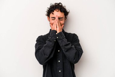 Beyaz arka planda izole edilmiş genç beyaz bir adam el ele tutuşup, ağız kenarında dua ediyor, kendinden emin..