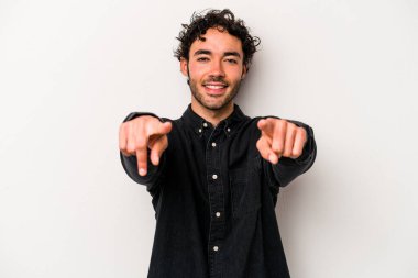 Beyaz arka planda soyutlanmış beyaz tenli genç adam öne bakan neşeli gülümsemeler..