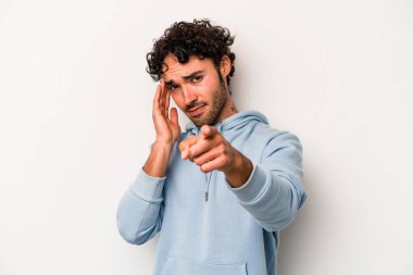 Beyaz arka planda izole edilmiş genç beyaz bir adam şakağı parmağıyla işaret ediyor, düşünüyor ve bir göreve odaklanıyor..