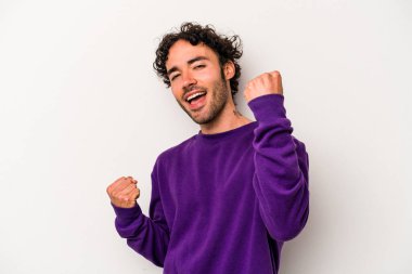 Beyaz arka planda izole edilmiş genç beyaz adam tasasız ve heyecanlı bir şekilde tezahürat yapıyor. Zafer konsepti.