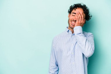 Beyaz arka planda izole olmuş genç beyaz bir adam gülüyor, kaygısız, doğal bir duygu..