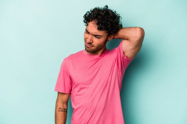 Beyaz arka planda izole edilmiş genç beyaz bir adam yorgun ve uykulu bir şekilde elini başının üstünde tutuyor..