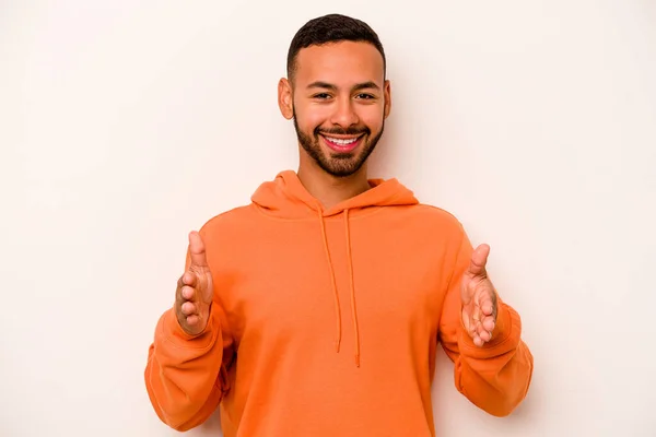 Young Hispanic Man Isolated White Background Holding Something Both Hands — 스톡 사진