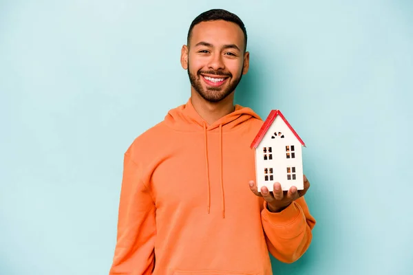 Young Hispanic Man Holding Toy House Isolated Blue Background Happy — Stock Photo, Image