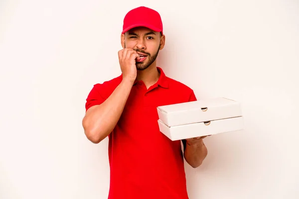 Young Hispanic Delivery Man Holding Pizzas Isolated White Background Biting — Stockfoto