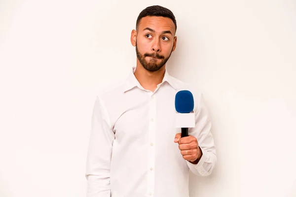 Young Hispanic Presenter Isolated Blue Background Confused Feels Doubtful Unsure — Stockfoto