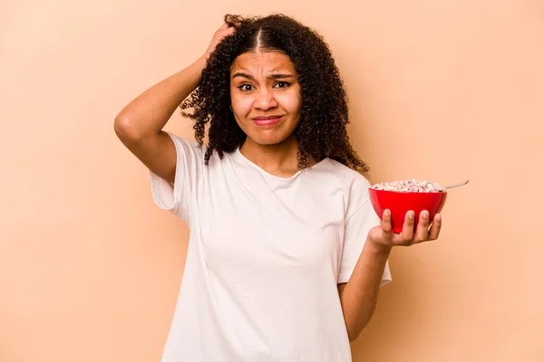 Young African American Woman Holding Bowl Cereals Isolated Beige Background — Stok fotoğraf