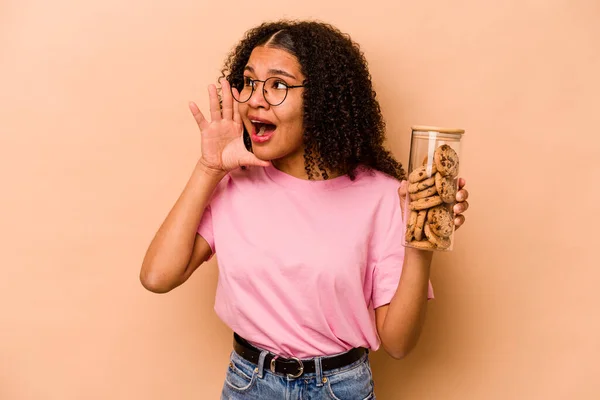 Young African American Woman Holding Cookies Jar Isolated Beige Background — Foto Stock