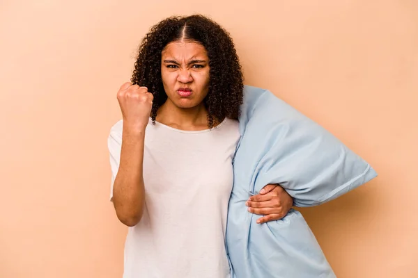 Young African American Woman Holding Pillow Isolated Beige Background Showing — Stok fotoğraf