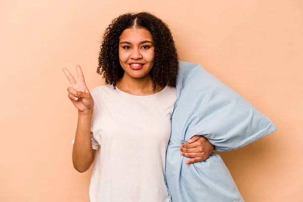 Young African American Woman Holding Pillow Isolated Beige Background Showing — 스톡 사진