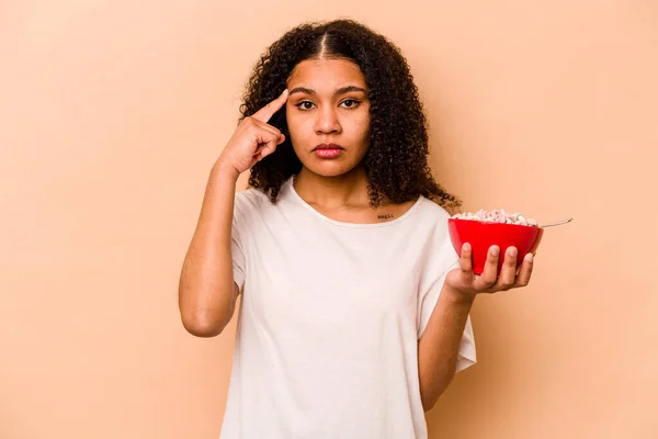 Young African American Woman Holding Bowl Cereals Isolated Beige Background — Stockfoto
