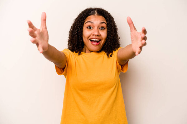 Young African American woman isolated on white background celebrating a victory or success, he is surprised and shocked.