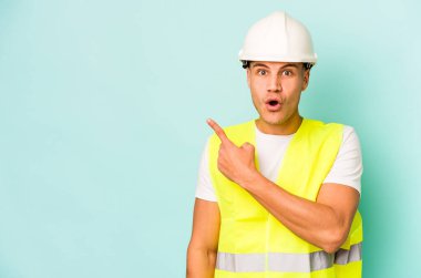 Kafkasyalı genç işçi, mavi arka planda izole edilmiş.