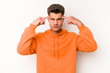 Beyaz arka planda izole edilmiş genç beyaz bir adam bir göreve odaklanmış, işaret parmaklarını işaret ediyor..