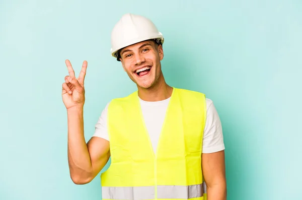 Young Laborer Caucasian Man Isolated Blue Background Joyful Carefree Showing — Stock Photo, Image