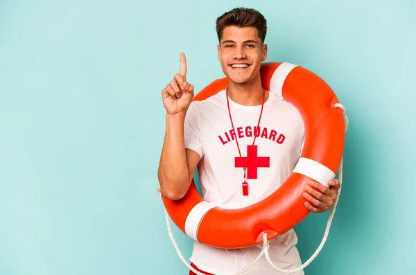 Young Caucasian Lifeguard Isolated Blue Background Showing Number One Finger —  Fotos de Stock