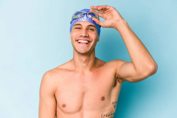 Young Caucasian Swimmer Man Isolated Blue Background — Foto de Stock