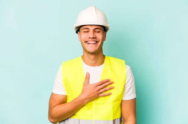 Young Laborer Caucasian Man Isolated Blue Background Laughs Out Loudly — 스톡 사진