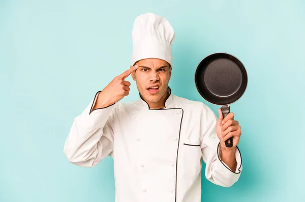 Young Caucasian Chef Man Holding Flying Pan Isolated Blue Background — Stock Photo, Image