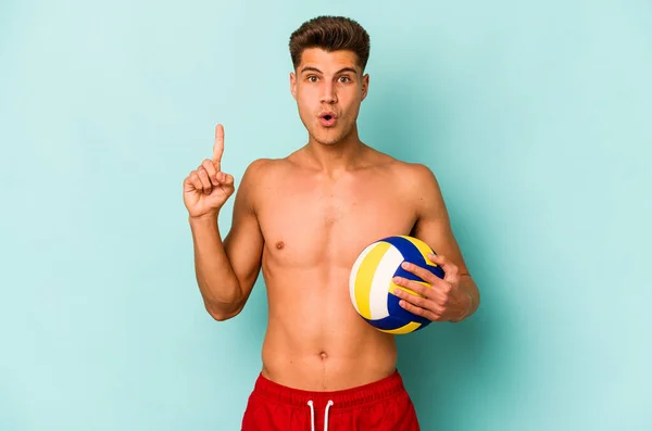 Young Caucasian Man Playing Volley Isolated Blue Background Having Some — Stok fotoğraf