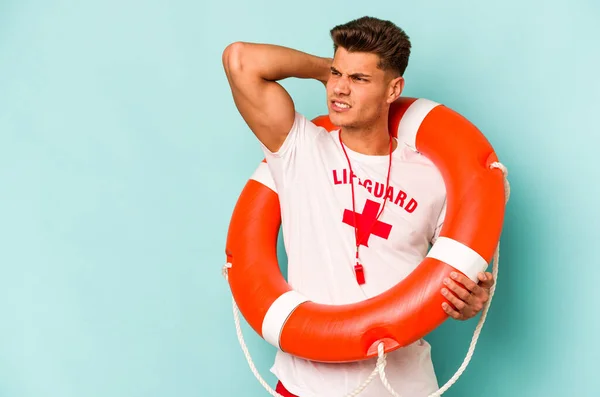 Young Caucasian Lifeguard Isolated Blue Background Touching Back Head Thinking — Stock fotografie