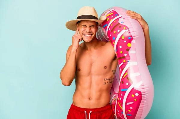 Young Caucasian Man Holding Inflatable Donut Isolated Blue Background Covering — Stock fotografie