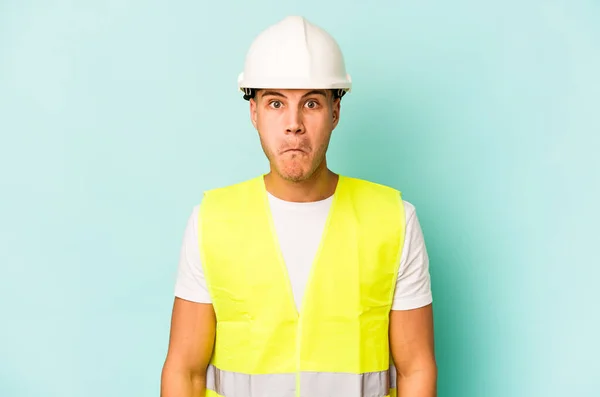 Young Laborer Caucasian Man Isolated Blue Background Shrugs Shoulders Open — Stock Photo, Image