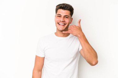 Beyaz arka planda izole edilmiş genç beyaz bir adam parmakları olan bir cep telefonu hareketi gösteriyor..