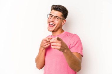 Beyaz arka planda soyutlanmış beyaz tenli genç adam öne bakan neşeli gülümsemeler..