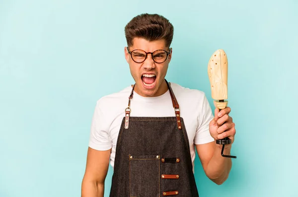 Young Caucasian Shoemaker Isolated Blue Background Screaming Very Angry Aggressive — Foto Stock