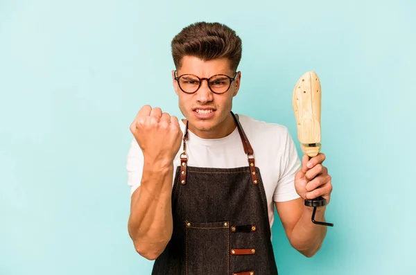 Young Caucasian Shoemaker Isolated Blue Background Showing Fist Camera Aggressive — Foto Stock