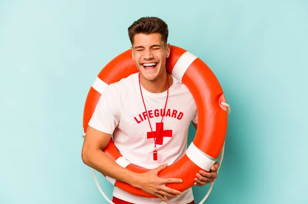 Joven Salvavidas Caucásico Aislado Sobre Fondo Azul Riendo Divirtiéndose — Foto de Stock