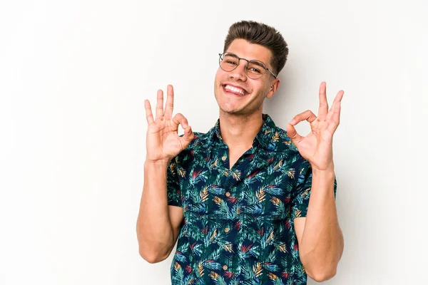 Beyaz arka planda izole edilmiş genç beyaz bir adam neşeli ve kendinden emin..