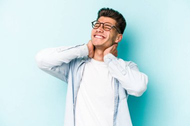 Kafkasyalı genç bir adam mavi arka planda izole edilmiş. Durağan yaşam tarzından dolayı boyun ağrısı çekiyor..