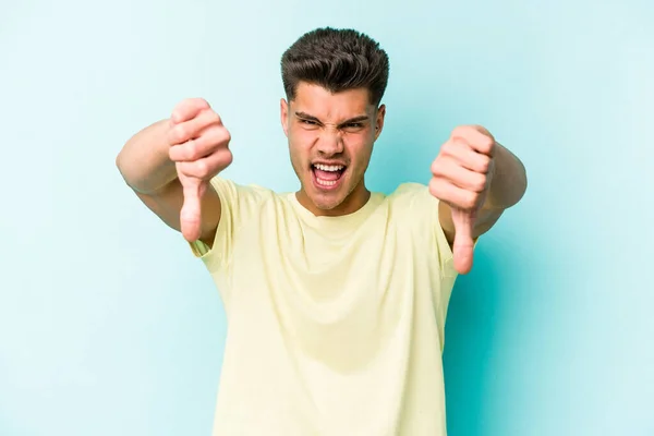 Young Caucasian Man Isolated Blue Background Showing Thumb Expressing Dislike — Stock Photo, Image