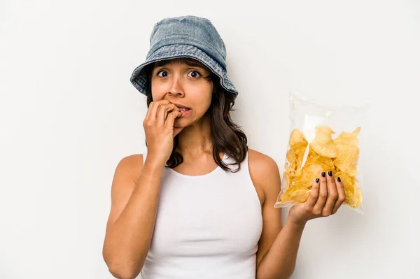 Young Hispanic Woman Holding Bag Chips Isolated White Background Biting — Φωτογραφία Αρχείου