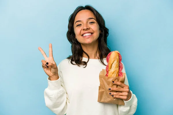 Young Hispanic Woman Eating Sandwich Isolates Blue Background Joyful Carefree — Photo