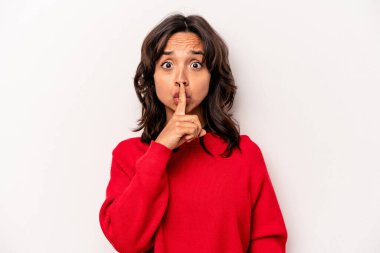 Beyaz arka planda izole edilmiş genç İspanyol kadın ya sır saklıyor ya da sessizlik istiyor..