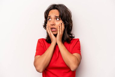 Beyaz arka planda izole edilmiş genç İspanyol kadın korkmuş ve korkmuş..