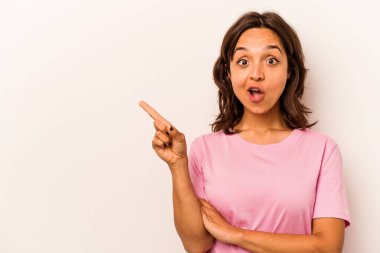 Young hispanic woman isolated on white background pointing to the side