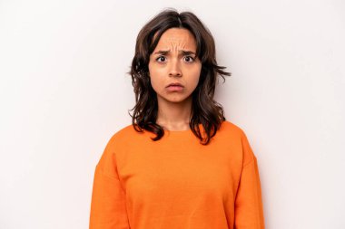 Genç İspanyol kadın beyaz arka planda izole edilmiş üzgün, ciddi yüzlü, mutsuz ve hoşnutsuz..