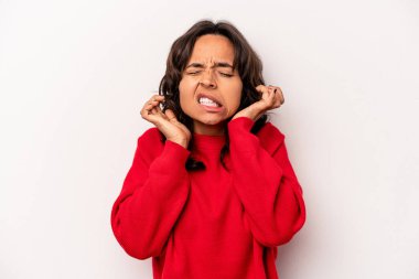 Beyaz arka planda izole edilmiş genç İspanyol kadın kulaklarını elleriyle kapatıyor..