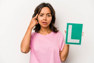 Genç İspanyol kadın elinde acemi sürücü imzası tutuyordu. Beyaz arka planda izole bir şekilde işaret parmağıyla hayal kırıklığı işareti yapıyordu..