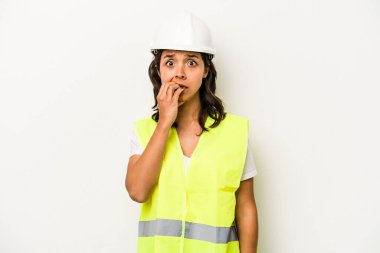 Beyaz arka planda izole edilmiş, tırnak yiyen, gergin ve endişeli genç bir işçi kadın..