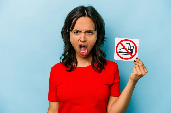 Young Hispanic Woman Holding Eating Sign Isolated Blue Background Screaming — Stockfoto